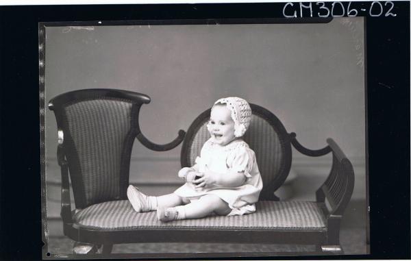 F/L Portrait of baby seated, wearing short dress and bonnet; 'Marelich'
