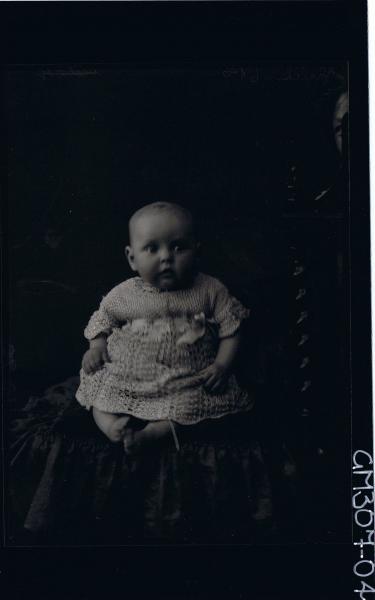F/L Portrait of baby, seated wearing ankle length dress; 'Schliker'