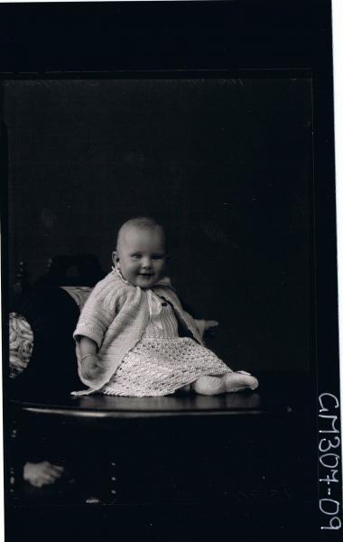 F/L Portrait of baby, seated on table wearing long dress and cardigan; 'Sheppard'
