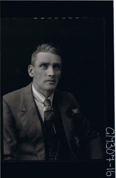 1/2 Portrait of man wearing three piece suit with rose on jacket; 'Skelt'