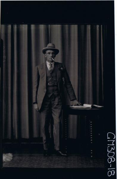 F/L Portrait of man standing wearing three piece suit, cigarette in mouth; 'Skelt'