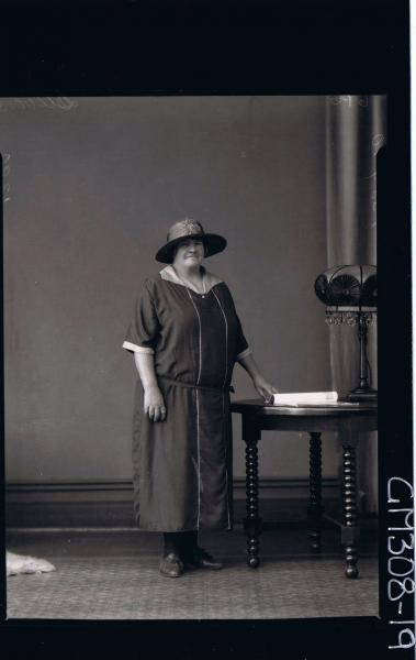 F/L Portrait of elderly lady standing, wearing three quarter length dress, hat; 'Stevens'