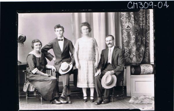 F/L Group Portrait of elderly and young man seated, elderly lady seated, young woman standing; 'Sain'