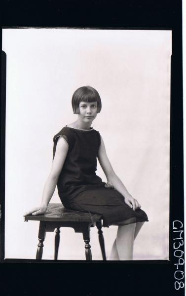 3/4 Portrait of girl seated wearing knee length dress; 'Sawyer'