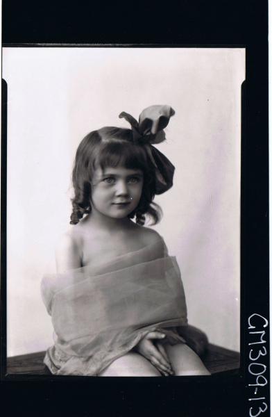 1/2 Portrait of girl seated, wearing material wrapped around body, ribbon in hair; 'Smith'