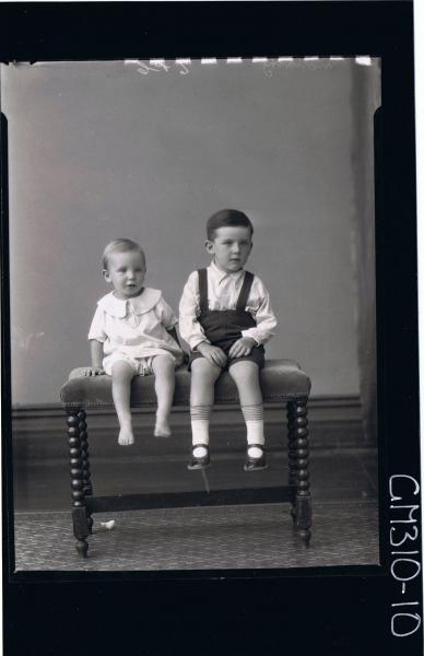 F/L Portrait of boy seated wearing shorts, shirt, child seated wearing pilchers, shirt, 'Moriarty'