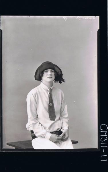 1/2 Portrait of teenage girl seated wearing dress with tie, thick belt around hips also wearing a hat; 'Medcalfe'