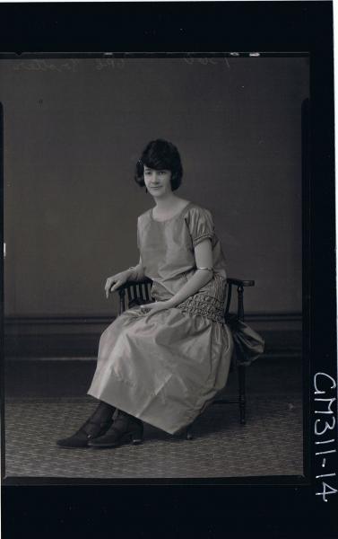 F/L Portrait of woman seated wearing ankle length satin dress 'Trotter'