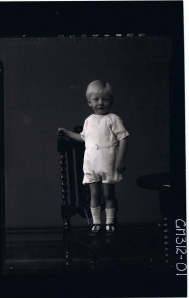 F/L Portrait of boy child standing on chair, wearing one piece shorts and shirt 'Thornton'