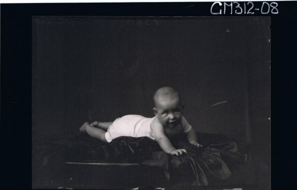 F/L Portrait of baby lying on table wearing vest and nappy 'Stewart'