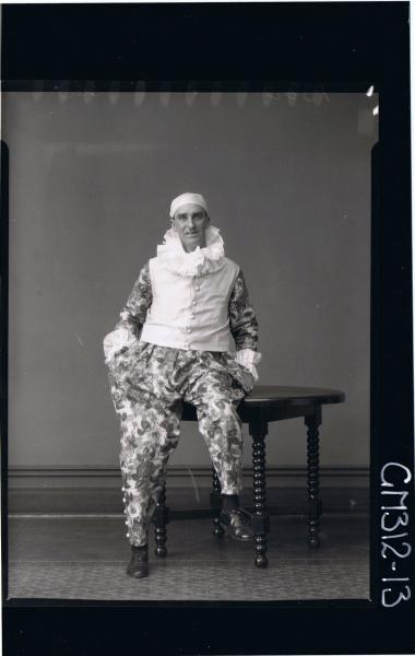 F/L Portrait of man seated wearing fancy dress clown costume 'Slee'