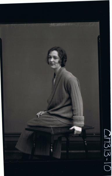 3/4 Portrait of woman seated, wearing 3/4 length skirt, jacket (side view) 'Smith'