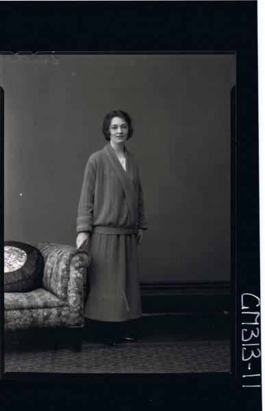 F/L Portrait of woman standing wearing 3/4 length skirt with matching jacket 'Smith'