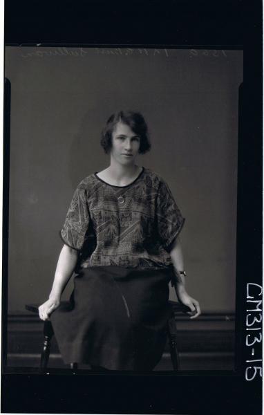 3/4 Portrait of woman seated wearing three quarter length skirt and patterned top 'Sullivan'