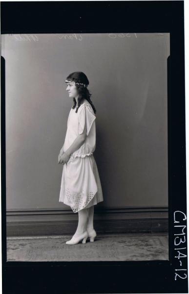 F/L Portrait of young woman standing wearing knee length evening dress, (side view) 'White'