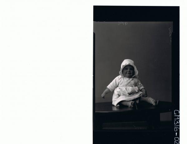 F/L Portrait of baby seated on table wearing dress, satin bonnet 'McKay'