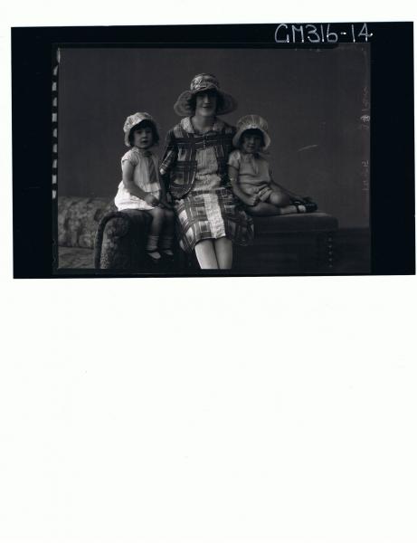 3/4 Portrait of woman seated, wearing knee length patterned dress,hat,2 girl children seated with short dresses'Mathews'