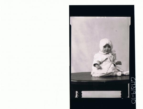 F/L Portrait of baby seated on table, wearing lace dress, jacket and bonnet 'Stack'