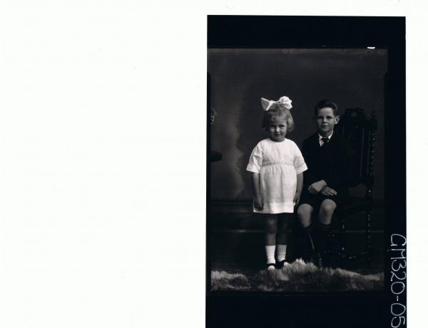 F/L Portrait of boy seated wearing school uniform, girl standing wearing short dress, ribbon in hair 'Smythe'