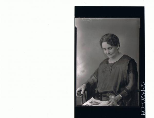 1/2 Portrait of elderly lady seated, looking at book 'Smith'