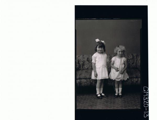 F/L Portrait of girl standing wearing short lace dress, ribbon in hair, girl standing wearing short dress 'Shocker'