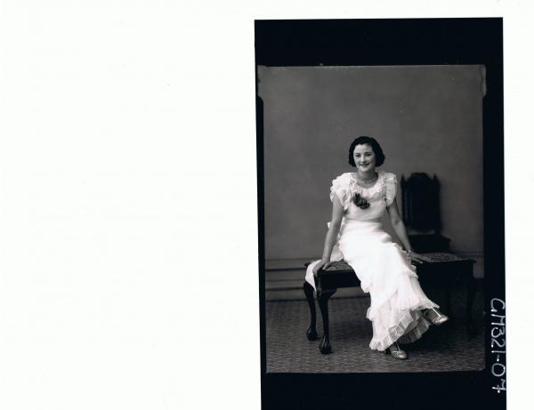 F/L Portrait of woman seated wearing long frilly evening dress; 'McFatty'