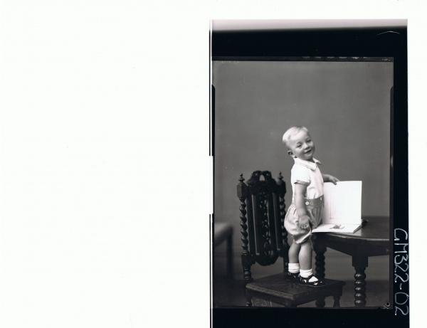 F/L Portrait of boy child standing on chair at table, wearing shorts and shirt; 'McQuoid'