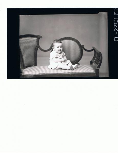 F/L Portrait of baby seated wearing short knitted dress; 'Martin'