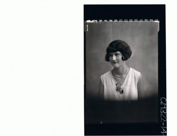 1/2 Portrait of woman wearing string of pearls, small bunch of flowers attached to neck of dress; 'Scotson'