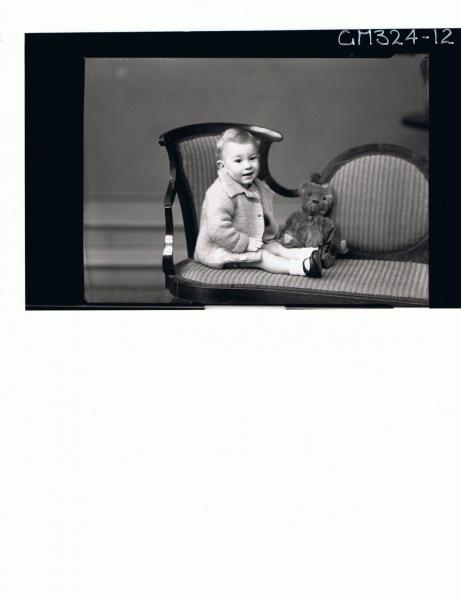 F/L Portrait of baby seated wearing woolly jacket, teddy bear next to baby; 'Leggert'