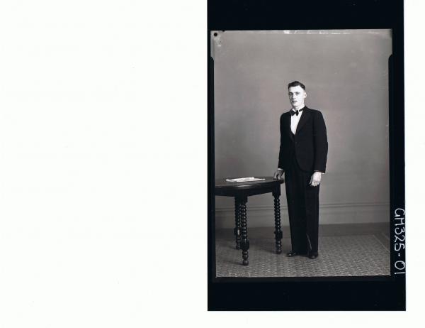 F/L Portrait of man standing wearing three piece suit, bow tie; 'Uybo'