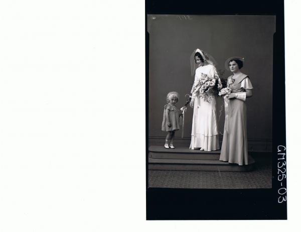F/L wedding Portrait of bride standing wearing long dress, veil and gloves, holding bouquet, young woman & child 'Lynch'