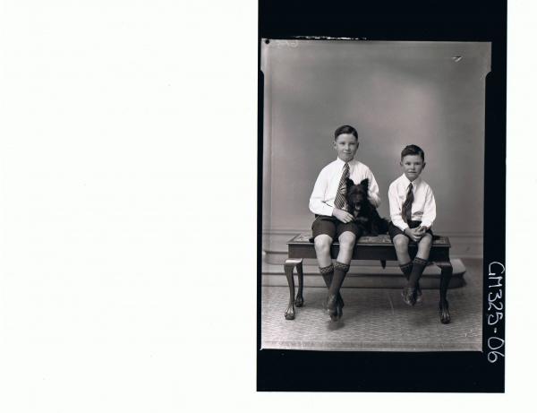 F/L Portrait of boy seated with dog, wearing shorts, tie boy seated wearing shorts, tie and shirt; 'Lyall'