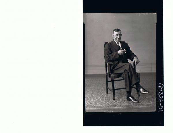 F/L Portrait of man seated wearing three piece suit, holding a cigarette; 'McGough'