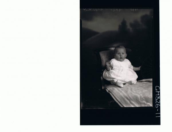 F/L Portrait of baby seated wearing embroidered dress; 'Sheppard'