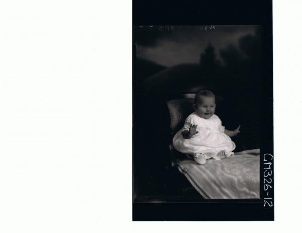 F/L Portrait of baby seated wearing embroidered dress; 'Sheppard'