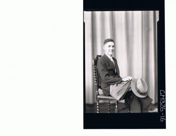 3/4 Portrait of man seated wearing suit, and holding a hat and coat; 'Stephens'