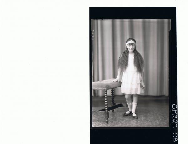 F/L Portrait of girl standing wearing short dress headband on forehead; 'Sutton'