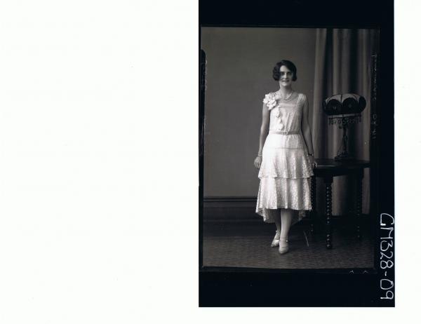 F/L Portrait of woman standing, wearing evening dress with two tiers and `handkerchief' hem; 'Scott'