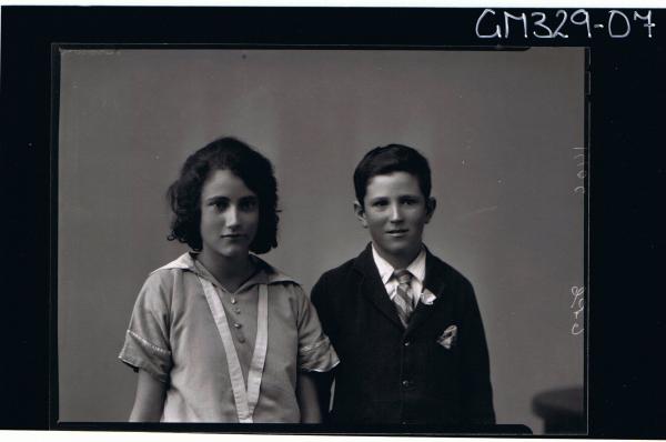 1/2 Portrait of girl wearing day dress, boy wearing shirt and tie and jacket; 'Brown'