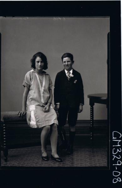 F/L Portrait of girl seated, wearing knee length dress, boy standing wearing shorts, shirt, tie and jacket; 'Brown'