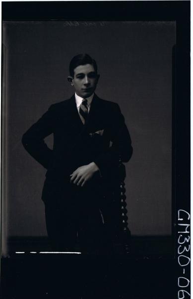 3/4 Portrait of young man standing wearing suit; 'McIvor'