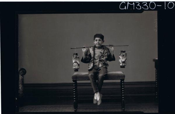 F/L Portrait of boy seated, wearing chinese fancy dress costume; 'Mills'