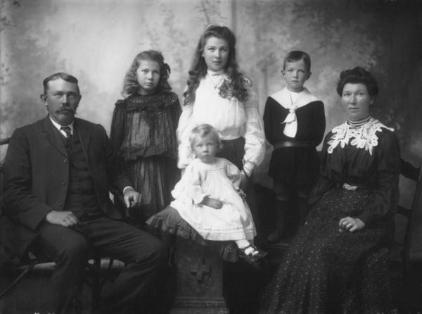 Mr J Rafface, family portrait, seated parents, note woman's lace collar, two girls and younger boy standing, seated child.