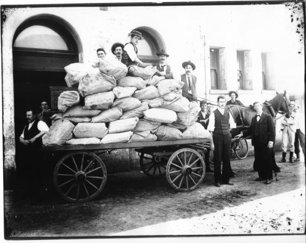 Horse drawn Cart with load of Mail Bags, staff around Cart outside Kalgoorlie Post Office.