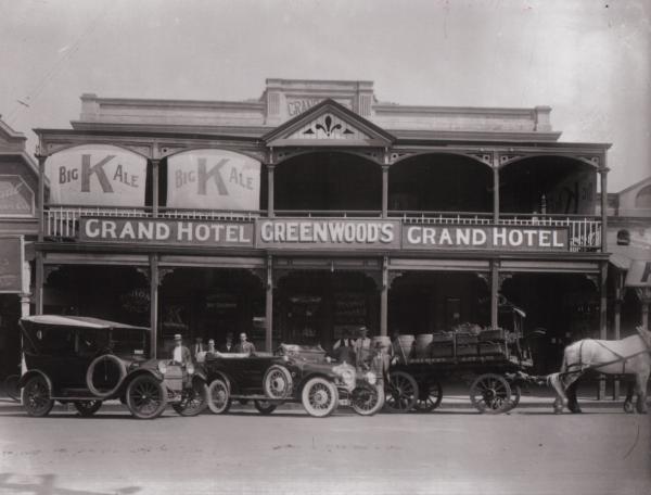 Motor Cars and Brewery Cart in front of Grand Hotel, Hannan Street - Facade visible. 1925