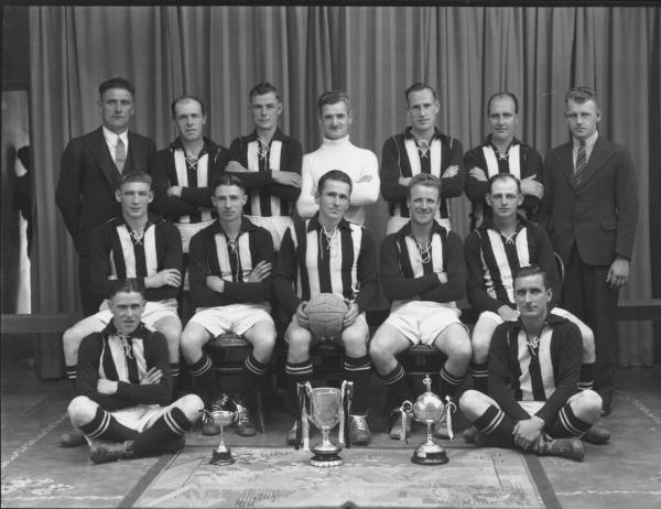 Soccer club team portrait with cups.