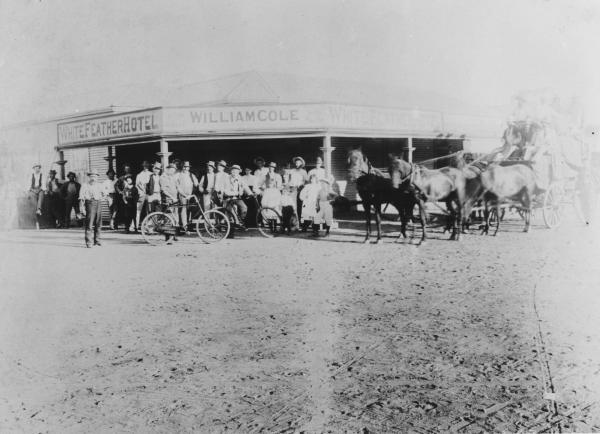 White Feather Hotel, Kanowna, licensee William Cole.  Group of men and children standing outside hotel two with bycycle's.  Stagecoach with four horses and several people aboard