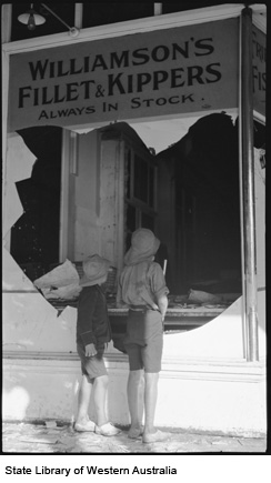 Two boys at the broken window of a store after the Kalgoorlie Riots