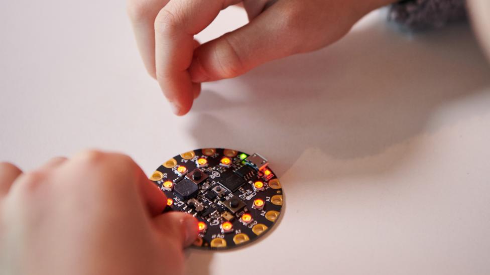 hands with a programable circuit board